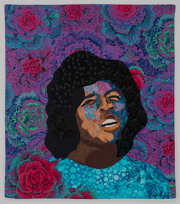 Fabric art of woman singing with flowers behind her by Alice Beasley